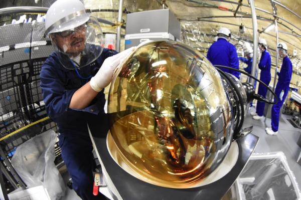 Image of a person holding a defective photomultiplier tubes